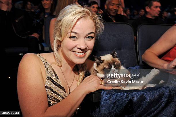 Personality Lenay Dunn poses with Grumpy Cat at the 2014 MTV Movie Awards at Nokia Theatre L.A. Live on April 13, 2014 in Los Angeles, California.