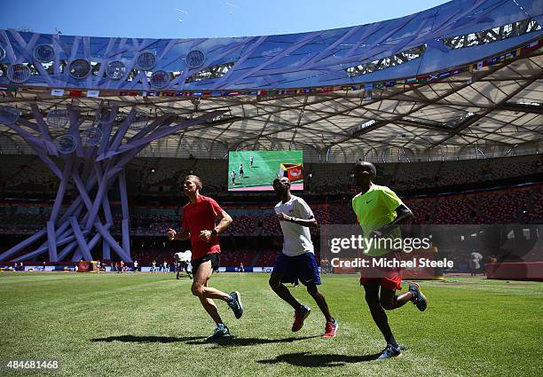 Galen Rupp of the United States, Mo Farah of Great Britain and Belgian athlete Bashir Abdi during a practice session ahead of the 15th IAAF World...