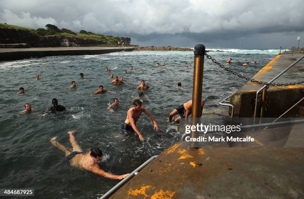 Swans players swim in the ocean during a Sydney Swans AFL recovery session at Clovelly Beach on April 14, 2014 in Sydney, Australia.