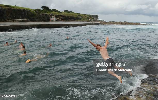 Gary Rohan jumps into the ocean during a Sydney Swans AFL recovery session at Clovelly Beach on April 14, 2014 in Sydney, Australia.