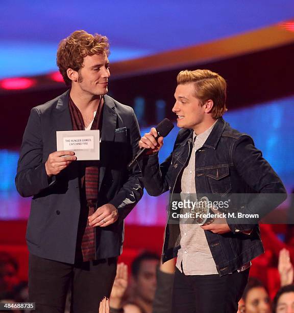 Actors Sam Claflin and Josh Hutcherson accept the Movie of the Year award for 'The Hunger Games: Catching Fire' onstage at the 2014 MTV Movie Awards...
