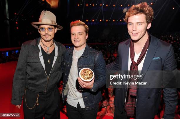 Actor Johnny Depp poses with actors Sam Claflin and Josh Hutcherson, winners of the Movie of the Year award for 'The Hunger Games: Catching Fire,' at...