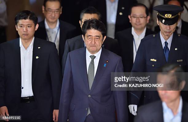 Japan's Prime Minister Shinzo Abe arrives to attend a special committee session in the upper house of parliament in Tokyo on August 21, 2015. The...