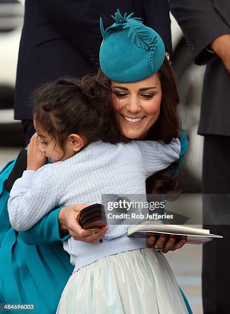 Catherine, Duchess of Cambridge receives a hug from a young fan at the official greeting at Dunedin International Airport on April 13, 2014 in...