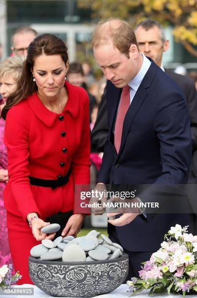 Britain's Prince William and his wife Catherine, the Duchess of Cambridge , lay a stone during a visit to the CTV memorial site to remember those...