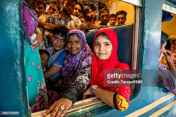 girl in red sitting in crowded compartment, dhaka, bangladesh - bangladesh stock pictures, royalty-free photos & images