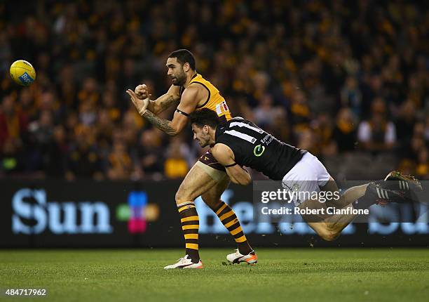Shaun Burgoyne of the Hawks gets his handball away from John Butcher of Port Adelaide during the round 21 AFL match between the Hawthorn Hawks and...