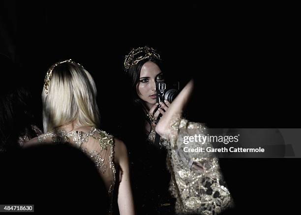 Model takes a photograph backstage before the Elie Saab show as part of Paris Fashion Week Haute Couture Fall/Winter 2015/2016 on July 8, 2015 in...