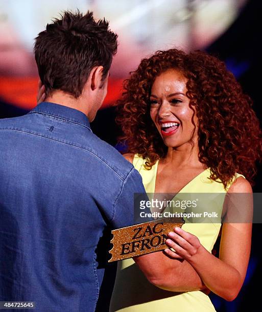 Actor Zac Efron and Tiffany Luce onstage at the 2014 MTV Movie Awards at Nokia Theatre L.A. Live on April 13, 2014 in Los Angeles, California.