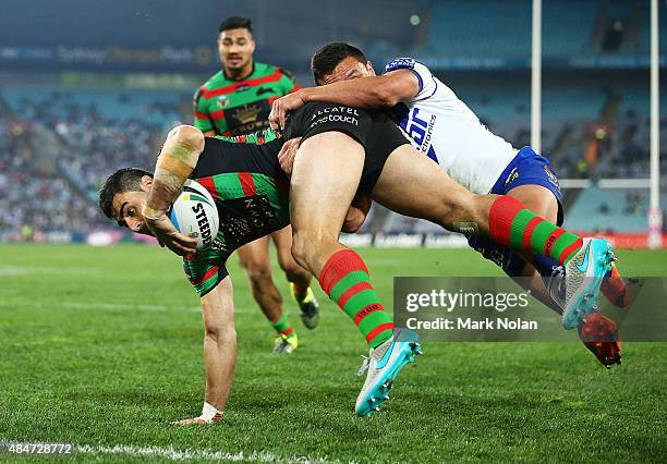 Bryson Goodwin of the Rabbitohs takes a high ball and dives to score a try during the round 24 NRL match between the South Sydney Rabbitohs and the...