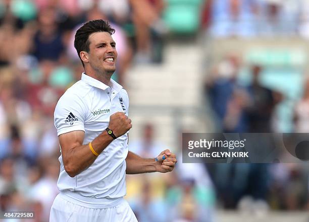 England's Steven Finn celebrates taking the wicket of Australia's Mitchell Marsh on the second day of the fifth Ashes cricket Test match between...