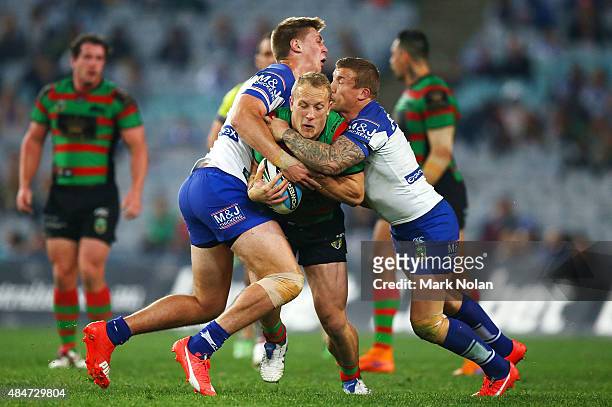 Jason Clark of the Rabbitohs is tackled during the round 24 NRL match between the South Sydney Rabbitohs and the Canterbury Bulldogs at ANZ Stadium...