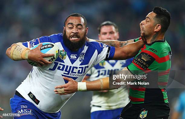 Sam Kasiano of the Bulldogs palms off John Sutton of the Rabbitohs during the round 24 NRL match between the South Sydney Rabbitohs and the...