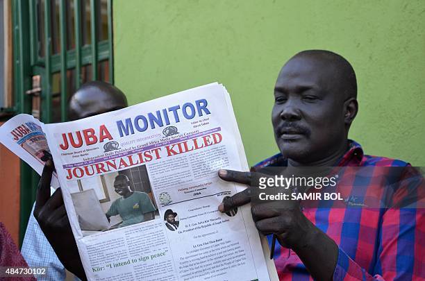 Man reads a copy of the Juba Monitor, with a heading referring to the killing of South Sudanese journalist Peter Moi of The New Nation newspaper, on...