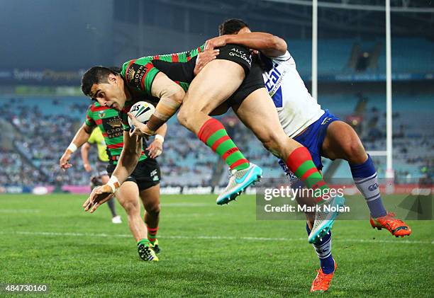 Bryson Goodwin of the Rabbitohs takes a high ball and dives to score a try during the round 24 NRL match between the South Sydney Rabbitohs and the...