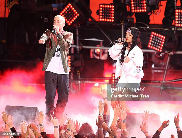 Eminem and Rihanna perform onstage during the 2014 MTV Movie Awards held at Nokia Theatre L.A. Live on April 13, 2014 in Los Angeles, California.