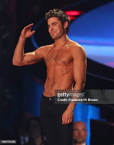 Actor Zac Efron accepts the Best Shirtless Performance award for 'That Awkward Moment' onstage at the 2014 MTV Movie Awards at Nokia Theatre L.A....