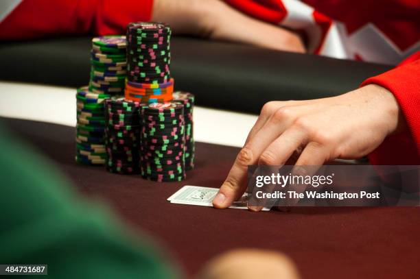 Greg Merson, of Laurel, who won the World Series of poker last year checks his hand at Maryland Live Casino Monday March 24, 2014 in Hanover, MD. He...