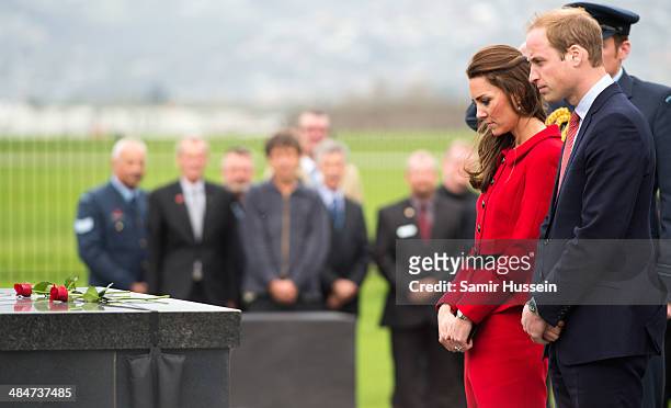 Catherine, Duchess of Cambridge and Prince William, Duke of Cambridge place roses at a Memorial Wall as they Wigram Air Force Museum on April 14,...
