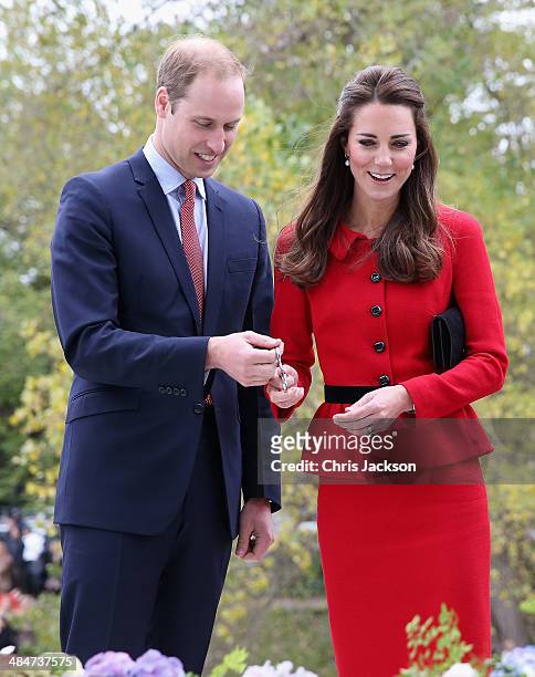 Catherine Duchess of Cambridge and Prince William, Duke of Cambridge prepare to cut the 'flower ribbon' when they officially open the Visitor's...