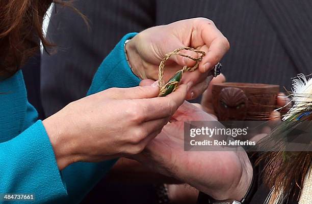 Catherine, Duchess of Cambridge receives a traditional Maori Greenstone gift at the official greeting at Dunedin International Airport on April 13,...