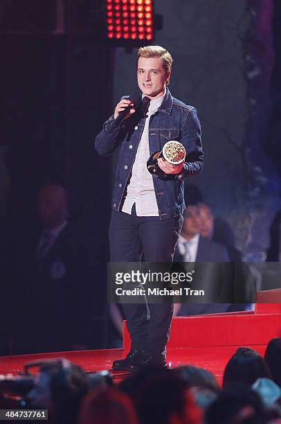 Josh Hutcherson accepts the Best Male Performance award for 'The Hunger Games: Catching Fire' onstage during the 2014 MTV Movie Awards held at Nokia...