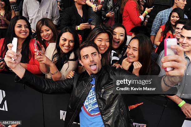 Actors Jonathan Bennett takes a selfie with fans during the 2014 MTV Movie Awards at Nokia Theatre L.A. Live on April 13, 2014 in Los Angeles,...