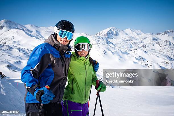 couple enjoying ski holiday. - ski hill stock pictures, royalty-free photos & images