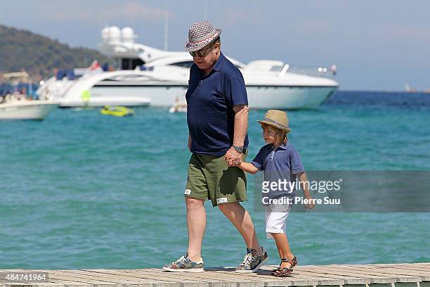 Elton John and their son Zachary Jackson Levon Furnish-John arrive at 'club55' for lunch on August 21, 2015 in Saint-Tropez, France.