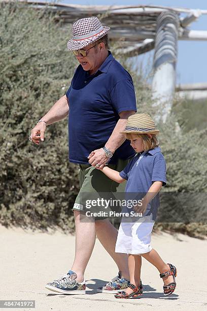 Elton John and their son Zachary Jackson Levon Furnish-John arrive at 'club55' for lunch on August 21, 2015 in Saint-Tropez, France.