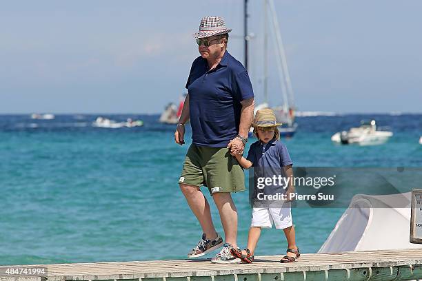 Elton John and their son Zachary Jackson Levon Furnish-John arrive at 'club55' for lunch on August 21, 2015 in Saint-Tropez, France.