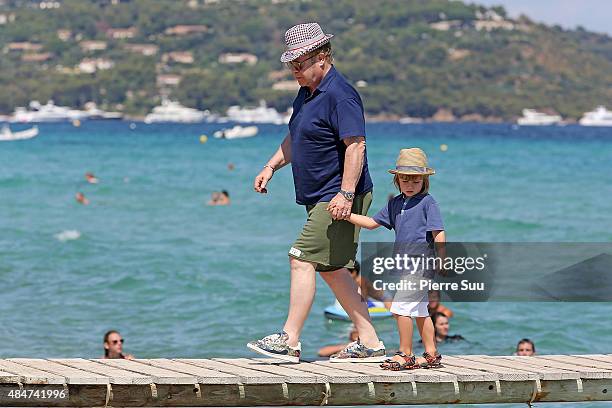 Elton John and their son Zachary Jackson Levon Furnish-John arrive at 'club55' for lunch on August 21, 2015 in Saint-Tropez, France.