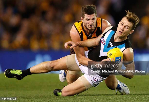 Robbie Gray of the Power is tackled by Ben Stratton of the Hawks during the 2015 AFL round 21 match between the Hawthorn Hawks and Port Adelaide...