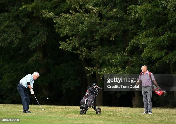 Stuart Rokes watches Nigel Fry of Faversham Golf Club take a shot from the 2nd fairway during the Golfplan Insurance PGA Pro-Captain Challenge -...