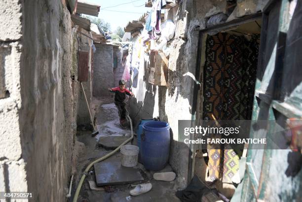 Child plays in the el-Wiam shantytown in the Djasr Kasentina Wilaya in the capital Algiers on April 9, 2014. Corruption, a recurring scourge for...