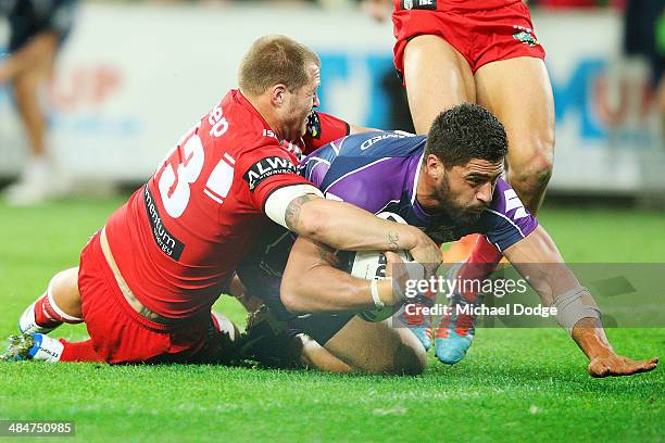 Jesse Bromwich of the Storm scores a try against Trent Merrin of the Dragons during the round 6 NRL match between the Melbourne Storm and the St...