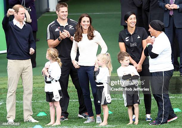 Catherine - Duchess of Cambridge laughs while Prince William, Duke of Cambridge celebrates his team scoring a try with All Blacks captain Richie...