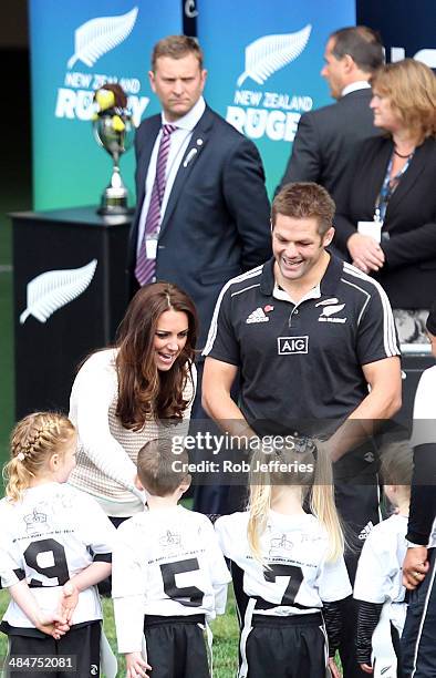 Catherine, Duchess of Cambridge talks with the junior rippa rugby players while All Blacks captain Richie McCaw looks on at Forsyth Barr Stadium,...