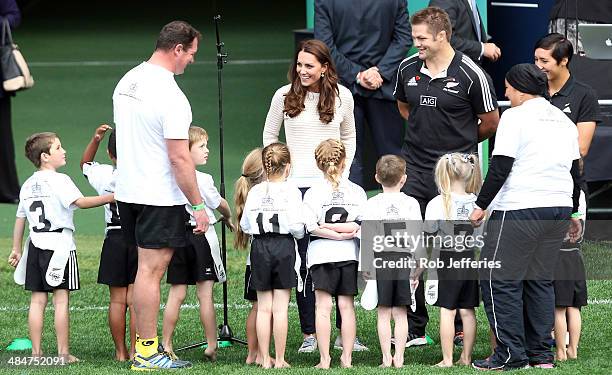 Catherine, Duchess of Cambridge encourages the junior rippa rugby players with All Blacks captain Richie McCaw at Forsyth Barr Stadium, Dunedin on...
