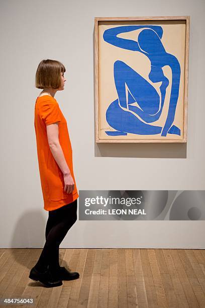 Gallery assistant poses next to "Nu bleu 1" by Henri Matisse at the "Henri Matisse: The Cut-Outs" exhibition at the Tate Modern gallery in central...