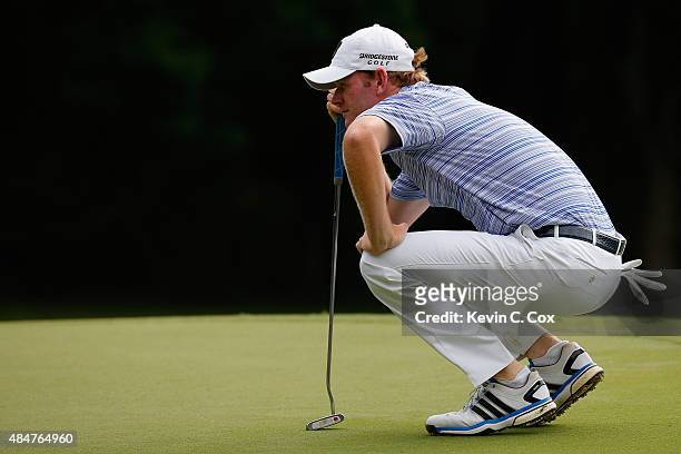 Brandt Snedeker lines up his putt on the 1st green during the second round of the Wyndham Championship at Sedgefield Country Club on August 21, 2015...