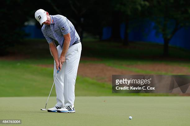 Brandt Snedeker putts on the 1st green during the second round of the Wyndham Championship at Sedgefield Country Club on August 21, 2015 in...