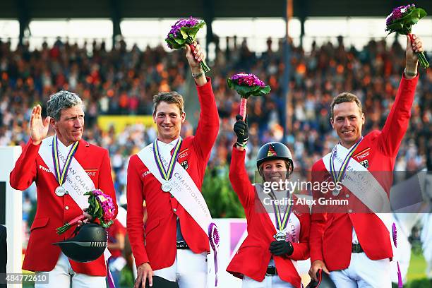 Ludger Beerbaum, Daniel Deusser, Meredith Michaels-Beerbaum and Christian Ahlmann of Germany celebrate finishing second in the Mercedes-Benz Prize...