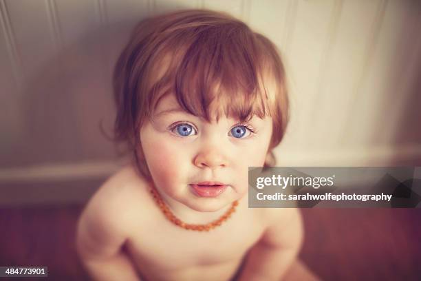 toddler in an amber necklace - bernstein stock-fotos und bilder