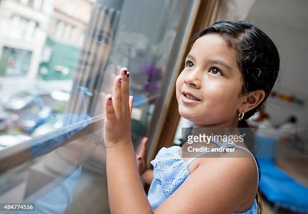 girl at home looking through a window - girl of desire stock pictures, royalty-free photos & images