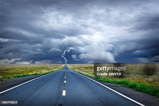 lightning bolt at the end of long rural road - vanish stock pictures, royalty-free photos & images