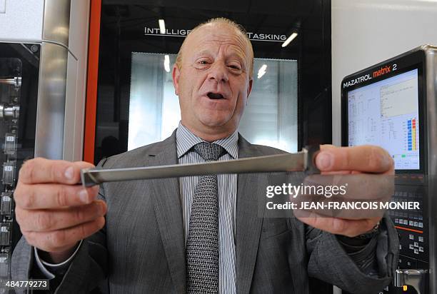 Etienne Galan, French purchasing manager of SNECMA, shows a TiAi turbine blade for the new jet engine LEAP of SNECMA , on April 14, 2014 at the...