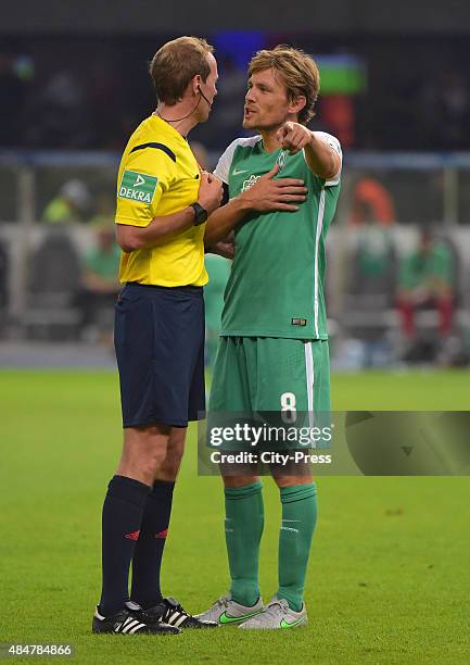 Clemens Fritz of Werder Bremen discusses with referee Sascha Stegemann during the game between Hertha BSC and Werder Bremen on August 21, 2015 in...