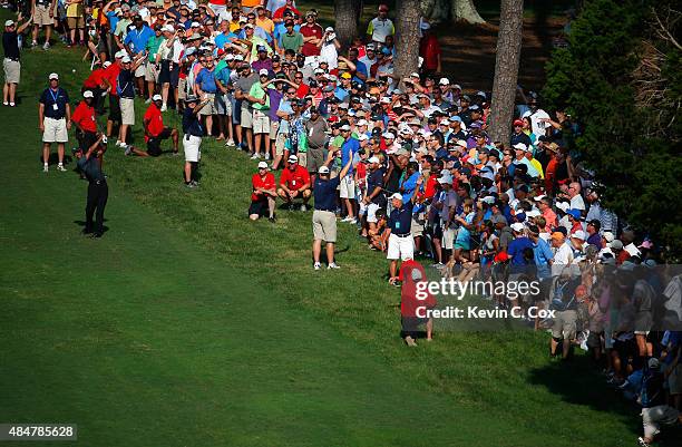 Tiger Woods plays his second shot on the 18th hole during the second round of the Wyndham Championship at Sedgefield Country Club on August 21, 2015...