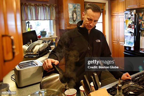 Bill Richard makes tea at his home in Dorchester on February 10, 2014 before leaving to take his daughter to Spaulding for an appointment. Jane...